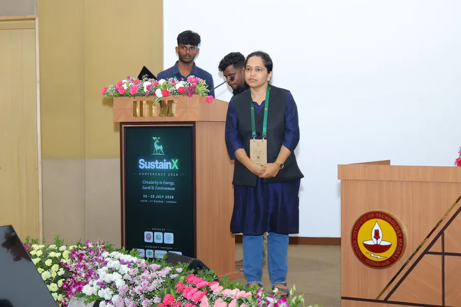 The session chair at the podium between talks
