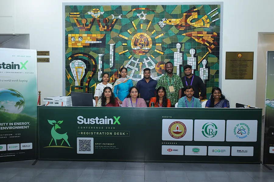 The registration team beneath the IC&SR mural on the final morning