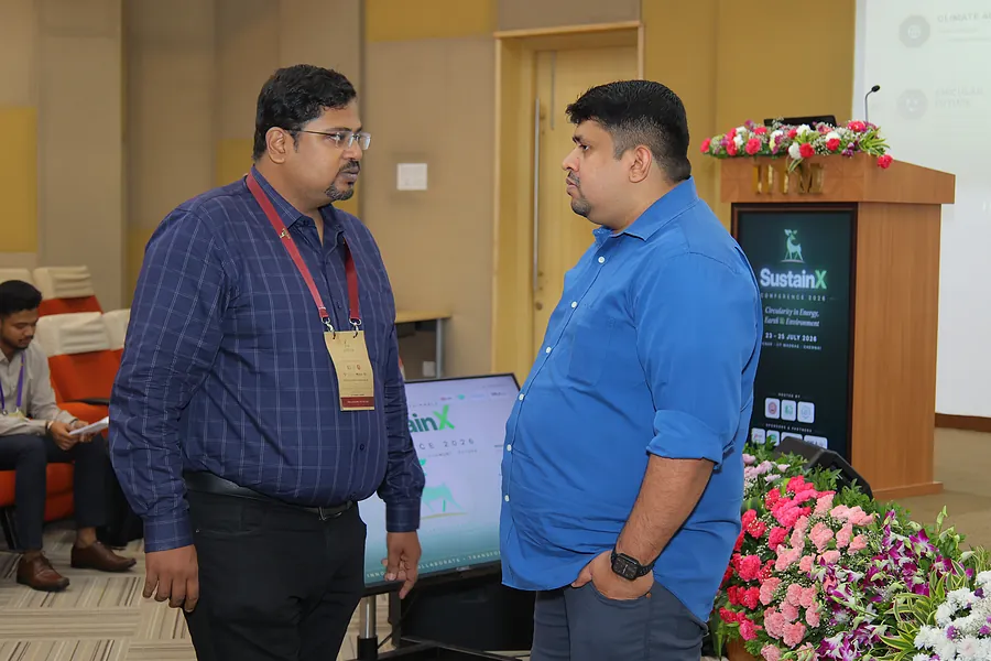 Conversation beside the podium between sessions