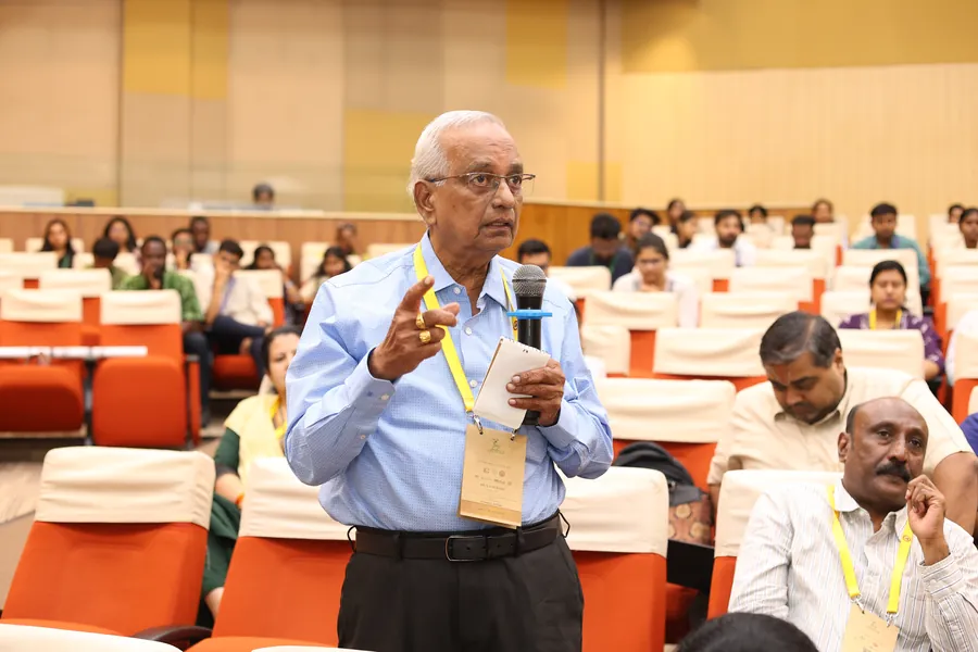 A senior delegate posing a question during the discussion