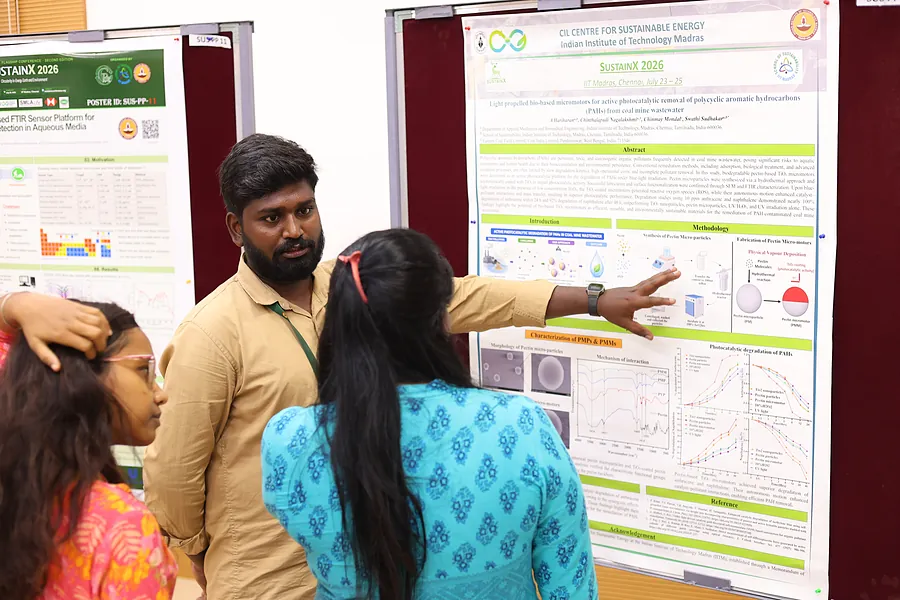 A presenter walking visitors through their poster
