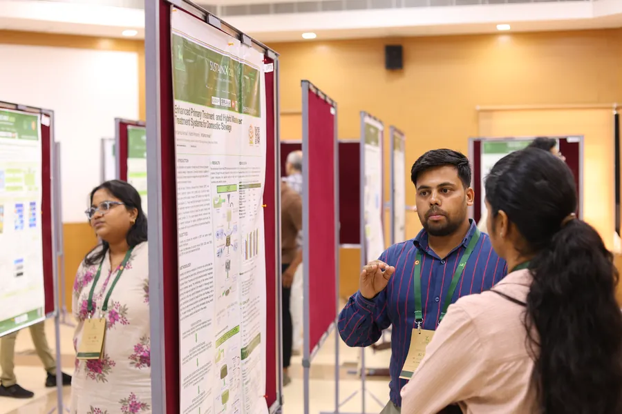 A presenter discussing his poster with visitors